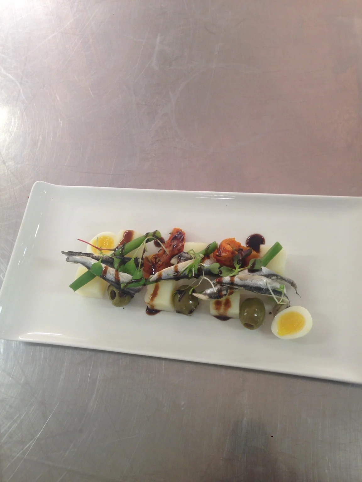 Fine dining fish starter with refined garnishes